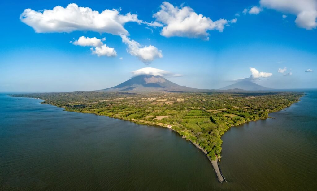 Explore the stunning aerial view of Ometepe Island and its volcanic landscape surrounded by serene waters.